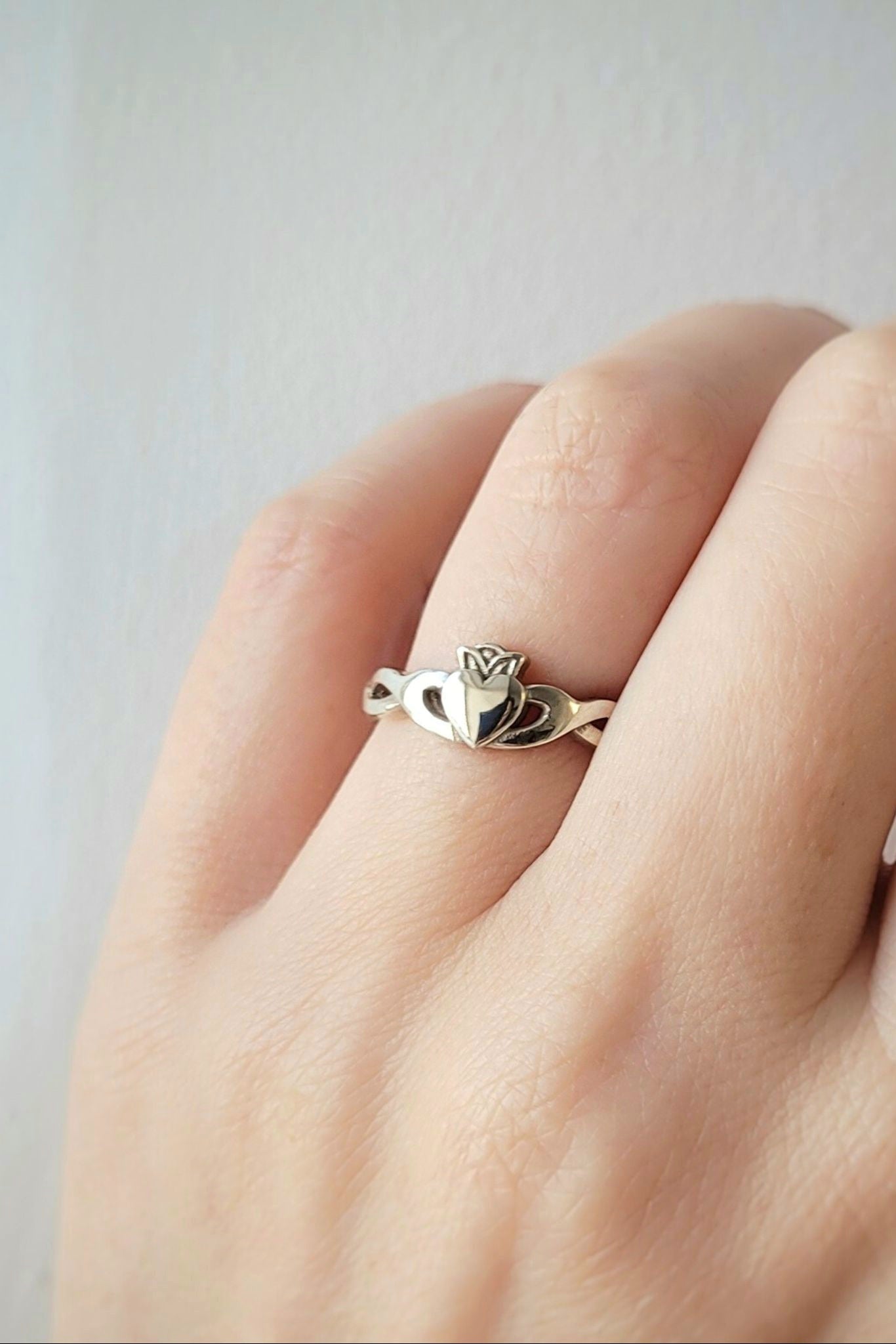 Claddagh ring twist band on models hand