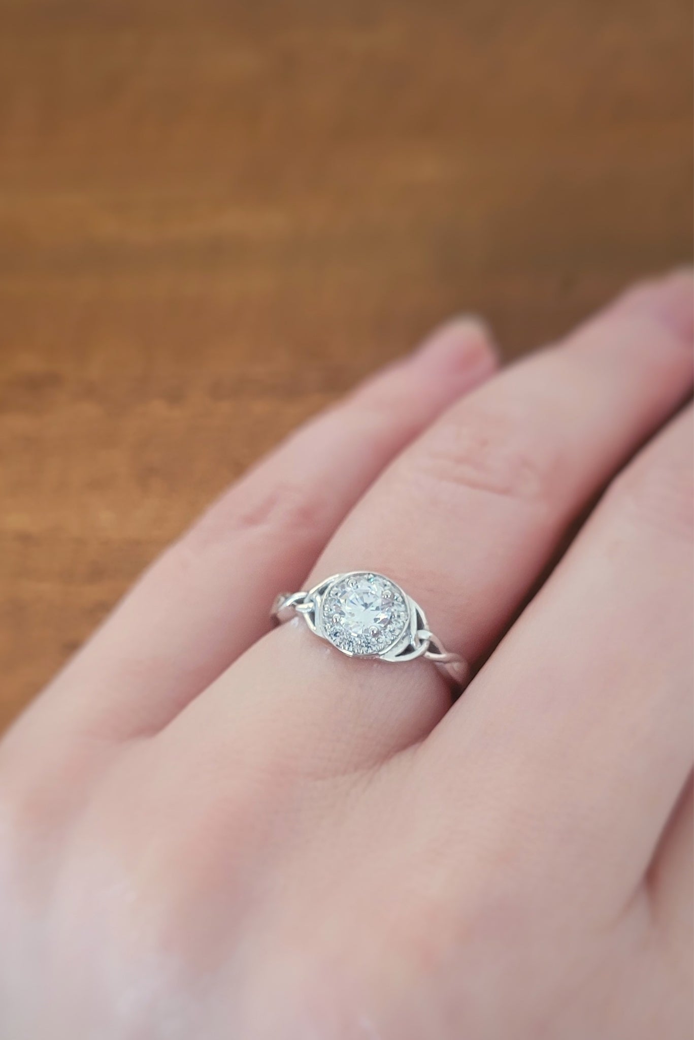 Halo Celtic Knot Engagement Ring on model's hand