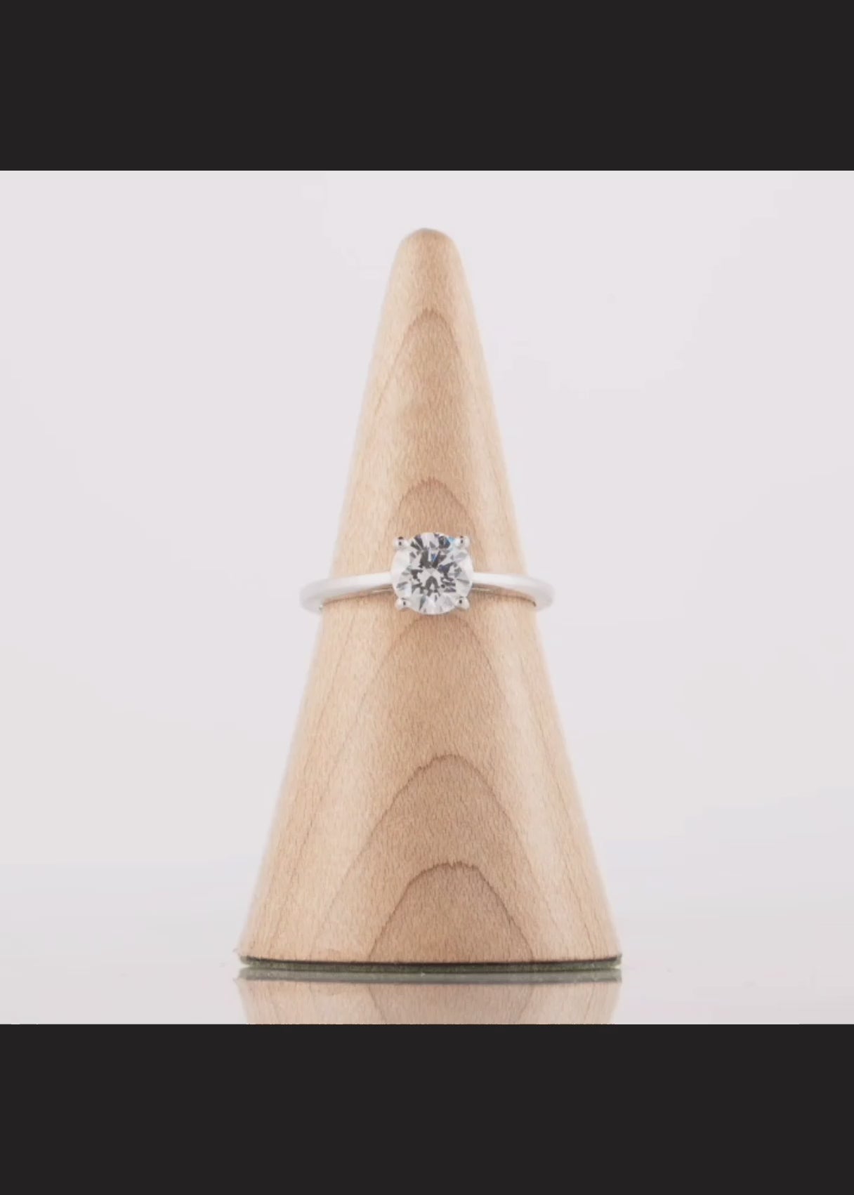 Video shows the solitaire diamond engagement ring rotating for a 360 degree view