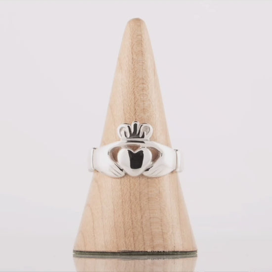 This video shows a 360 degree video of a large men's claddagh ring in silver