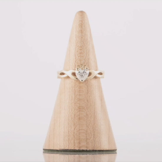 360 degree video of a diamond Claddagh Ring in gold. The video shows the double twist weave band