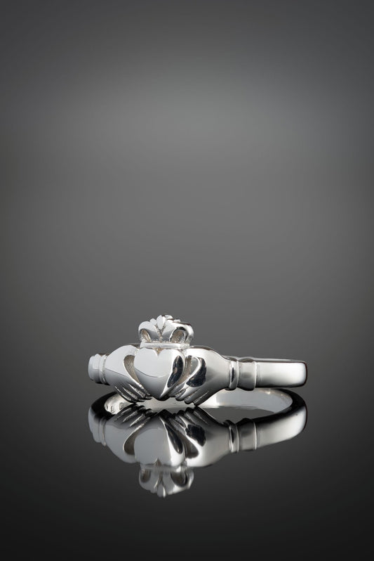 silver hertiage claddagh ring from the side on a black background