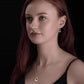 Model wears two tone Claddagh pendant made in silver with gold heart