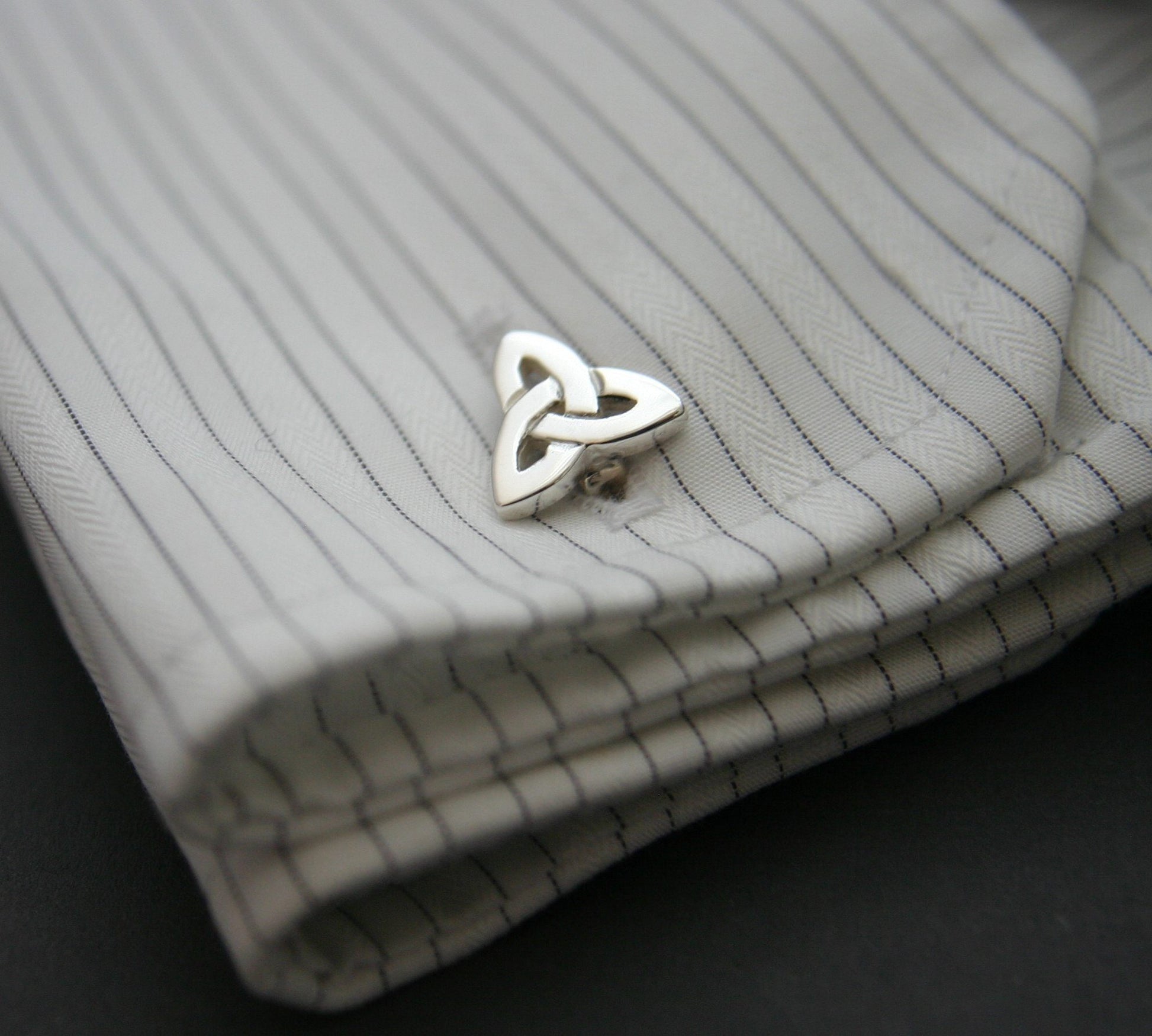 Silver Trinity Knot Cufflinks on a shirt cuff