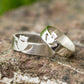 White Gold Claddagh wedding rings set in a modern style displayed on a rock