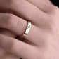 white gold ogham wedding ring on woman's hand