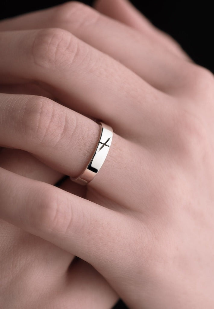 white gold ogham wedding ring on woman's hand