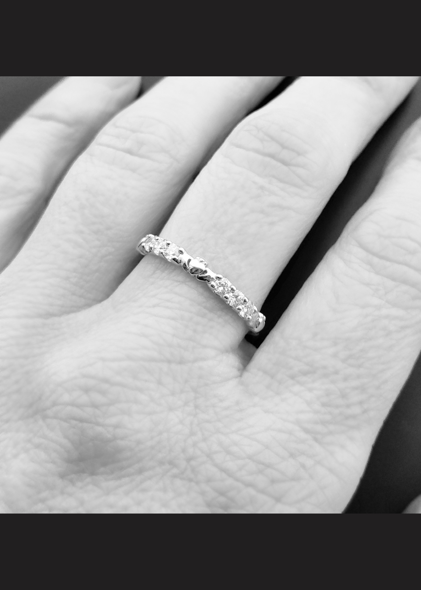 The claddagh eternity band on a model's hand