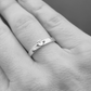 The dainty claddagh ring on a models hand