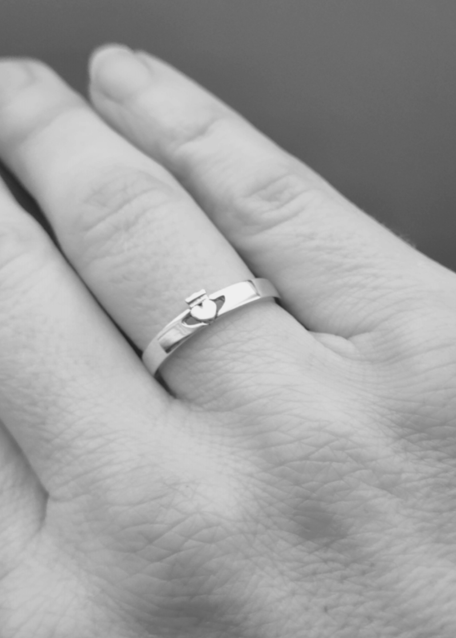 The dainty claddagh ring on a models hand