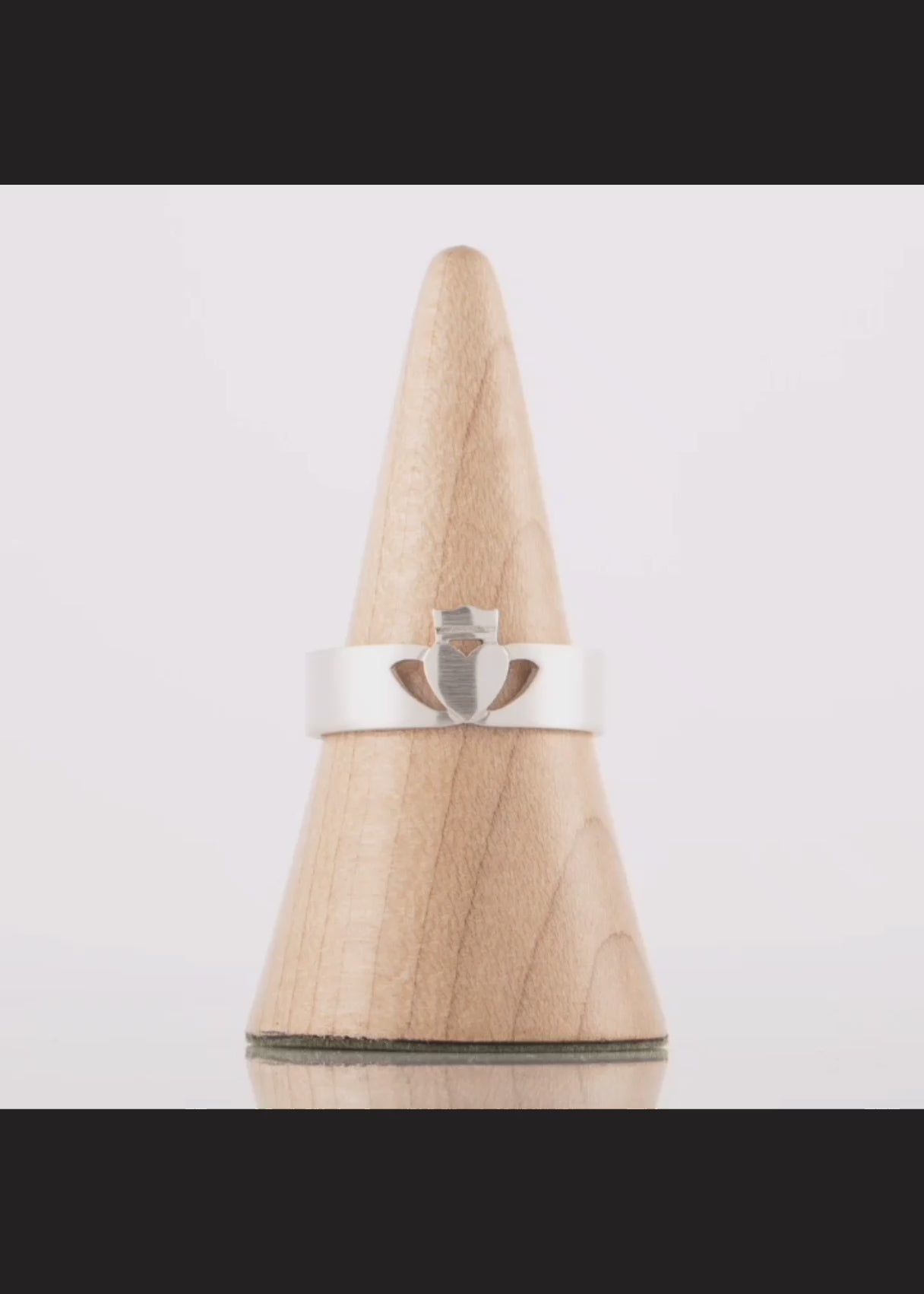 This video shows a 360 degree view of the white gold men's claddagh ring in a modern style with matte finish
