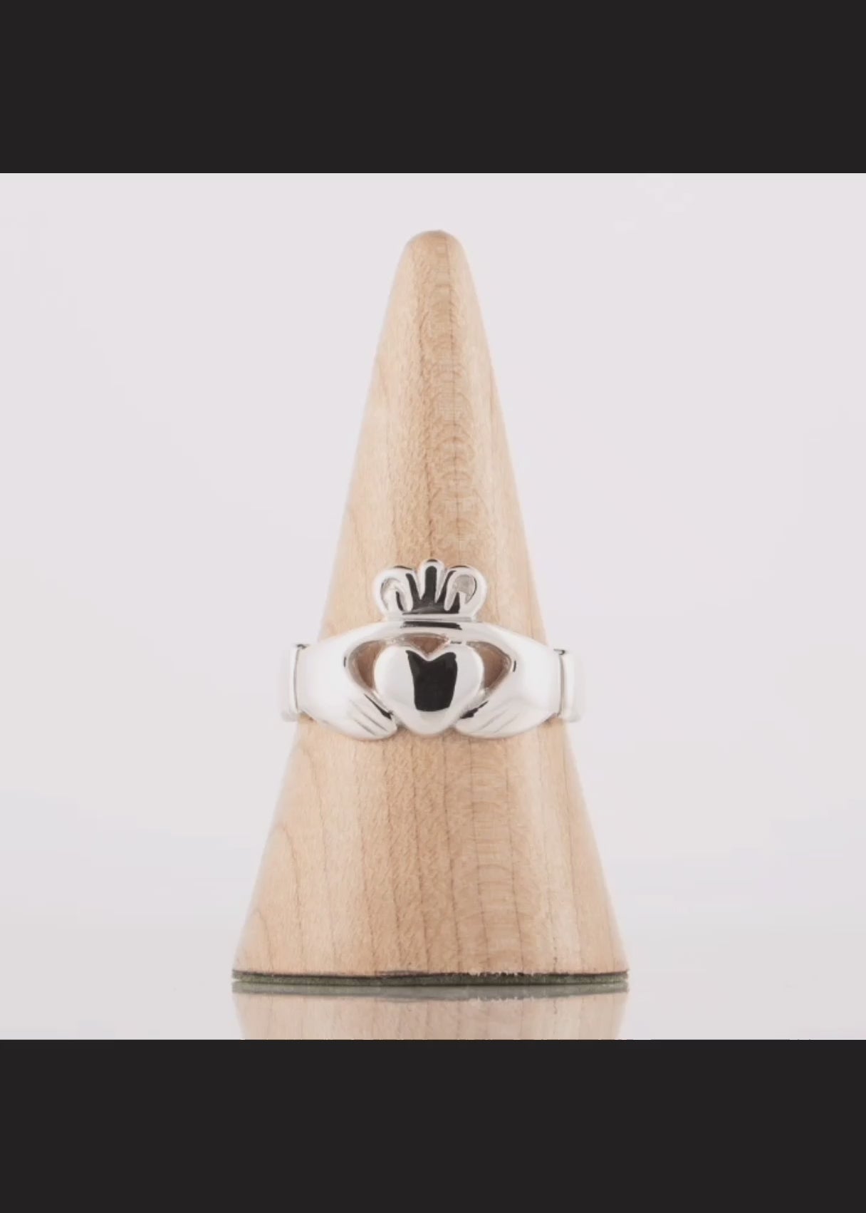 This video shows a 360 degree video of a large men's claddagh ring in silver