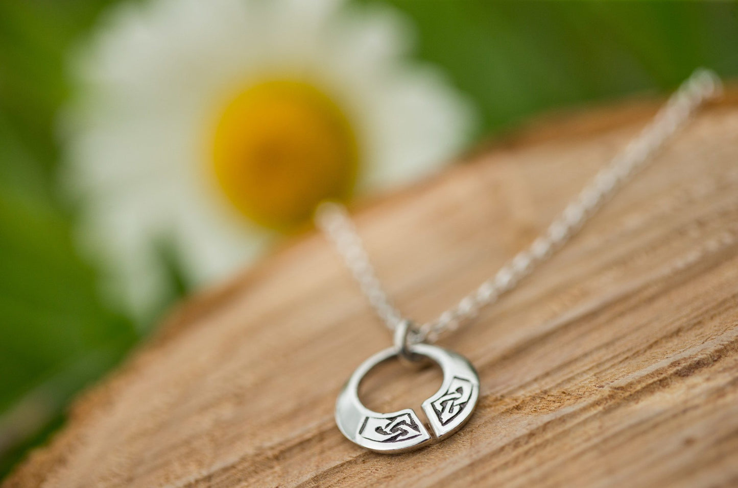 celtic torc pendant necklace on wooden display