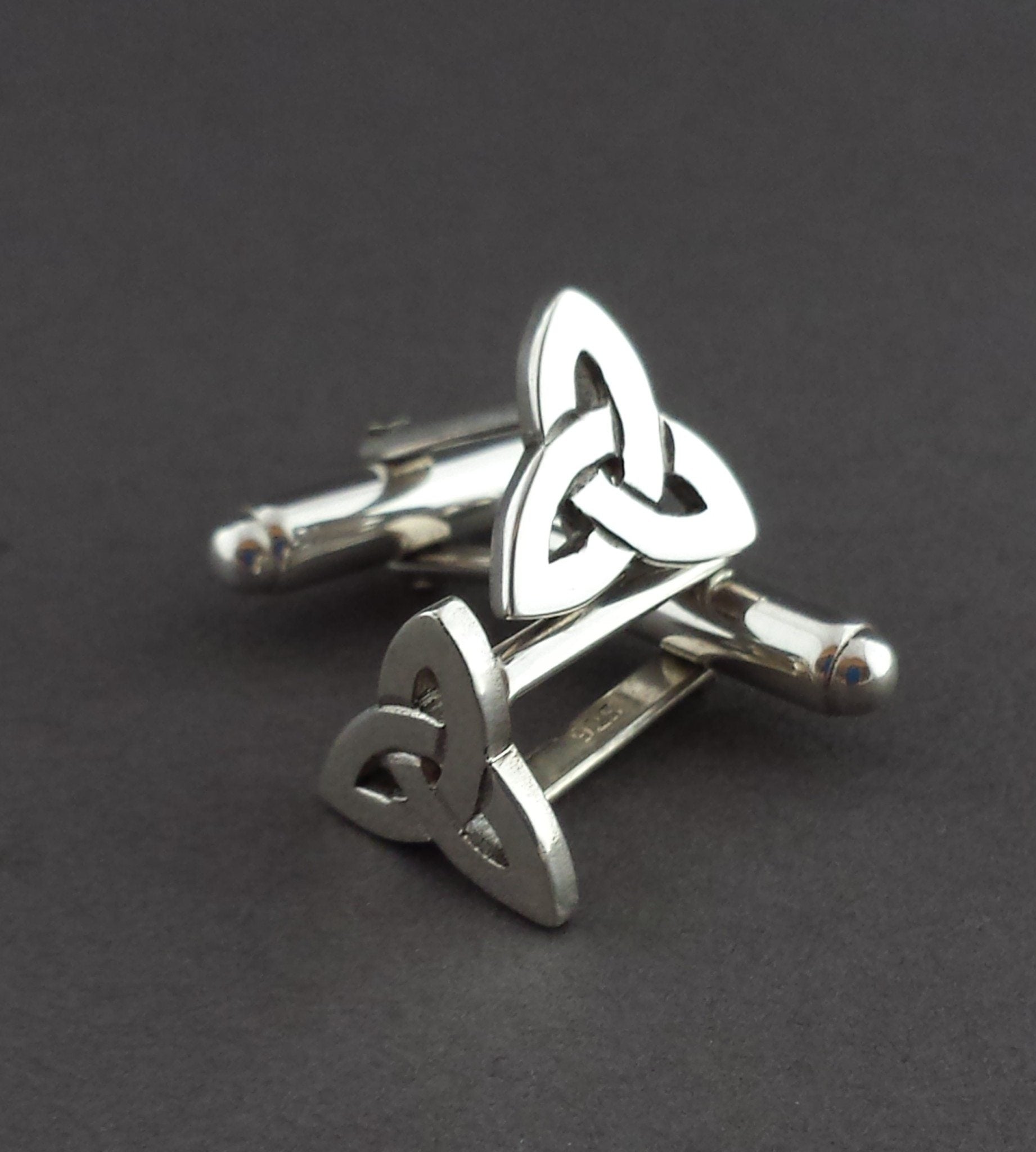 Silver Trinity Knot Cufflinks on a grey background