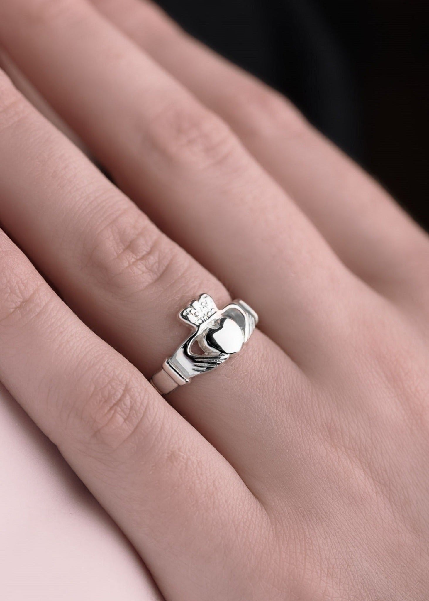 White gold claddagh ring on model